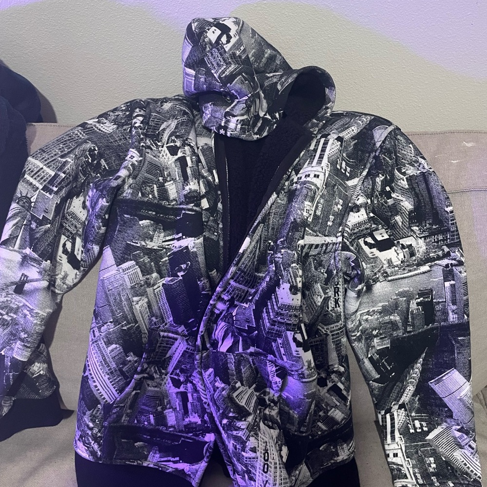 Zipper jacket with a city print on it.